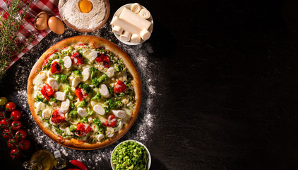 Pizza with broccoli, heart of palm and dried tomato. Top view, close up. Traditional Brazilian Pizza