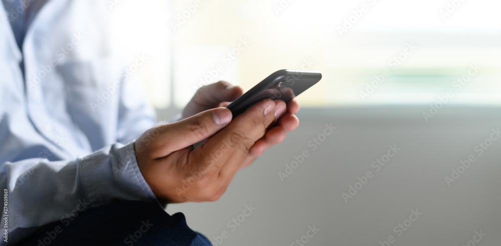 Aufkleber man holding en hands and using digital tablet mobile phone telephone with blank copy space scree