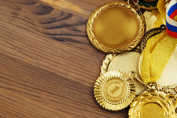 Golden medals on wooden table with room for text