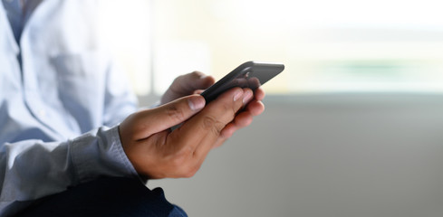 man holding en hands and using digital tablet  Mobile Phone telephone with blank copy space scree