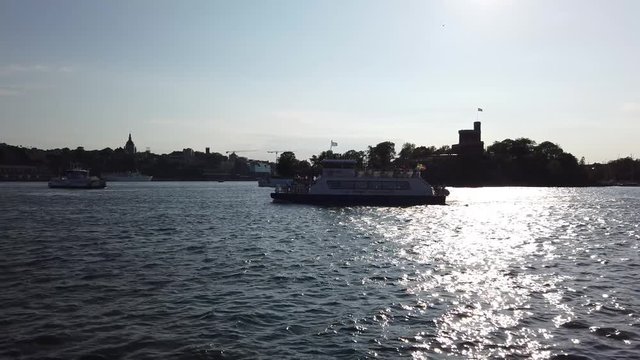 Stockholm, Djurgarden, Sweden - June (06) / 08 / 2019 : Archipelago canal. Fairy in background. Transport boat and private passenger boat. 4k 60fps.
