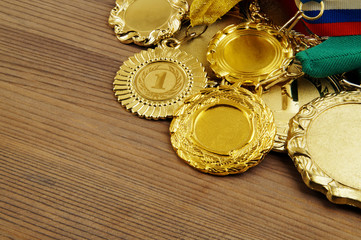Golden medals on wooden background