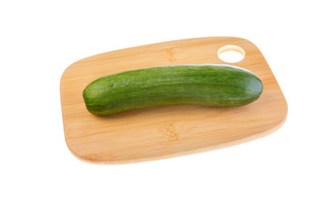 Ripe green cucumber on cutting board