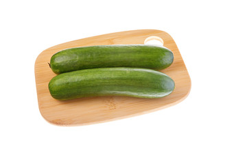 Pair of ripe green cucumbers on cutting board