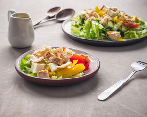 Light breakfast from Caesar salad on two tarekkas standing on a wooden table