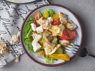 Light breakfast from Caesar salad on two tarekkas, standing on a cotton napkin with a pattern, fork, filmed from a high angle from close range