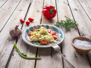 Baked cauliflower in seasoned eggs and krsanye vegetables on an old wooden table