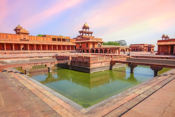 Naklejka premium Fatehpur Sikri ancient fort city with view of Anup Talao a concert stage surrounded by water with view of ancient architecture at Agra India
