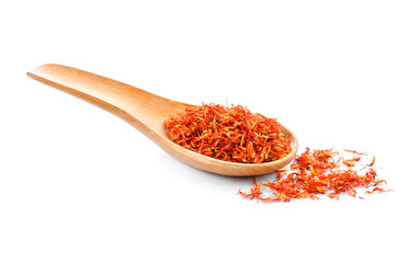 Safflower dried in wood spoon on white background