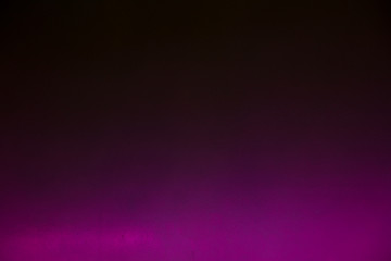 purple neon color light on black background. Place for text.