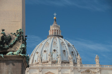 Fragment of the base of the obelisk and the main dome of the cathedral in the Vatican. Bright...