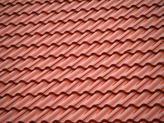 Red ceramic roof tiles, close up detail on house roof, seamless  pattern background.