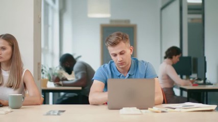 Tired man sleeping with notebook at coworking office. Exhausted business man