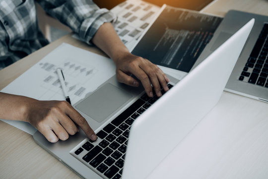 Two software developers are analyzing together about the code written into the program on the computer.