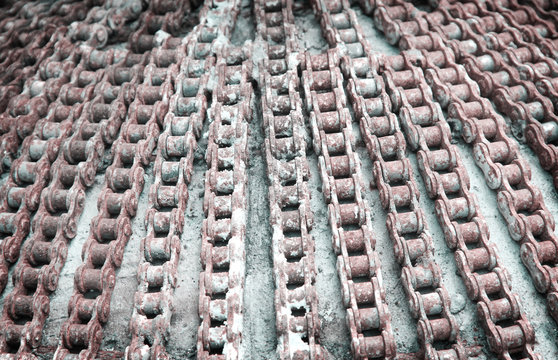 Abstract old motorcycle roller chain with rusty decorative on concrete texture  for background