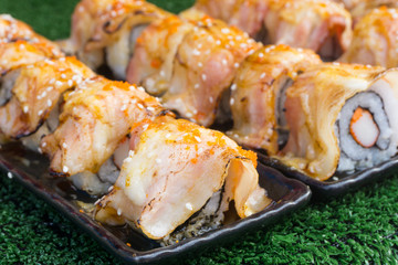 Japanese cuisine sushi roll bacon(3 layer pork) with shrims eggs and white sesame eat with pickled ginger, wasabi and soy sauce.Japanese traditional food.