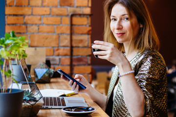Portrait of positive thoughtful female distance worker reading received email while checking mail...