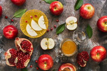 Red apples, pomegranate and honey. New Year - Rosh Hashana. Traditional Jewish food. Top view, overhead, flat lay.