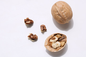 greek nut closeup on white background, walnut kernel, half of walnut, chopped walnut