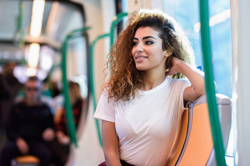 Arabic woman inside subway train. Arab girl in casual clothes.