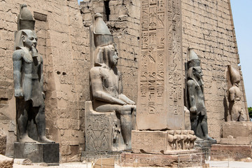 Fototapeta na wymiar Statues in front of Entrance to Luxor Temple, Ancient Egyptian temple complex east bank Nile River ancient Thebes