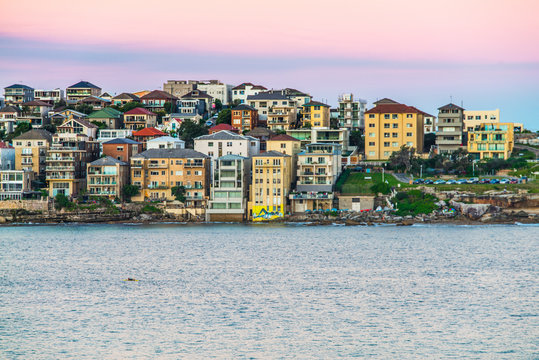 Houses in North Bondi Beach in Sydney during a purple sunset.