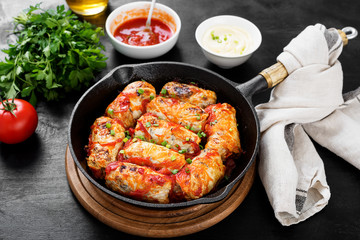 Traditional stuffed cabbage rolls with minced meat and rice, served in a tomato sauce.