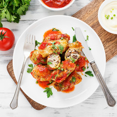 Traditional stuffed cabbage rolls with minced meat and rice, served in a tomato sauce.