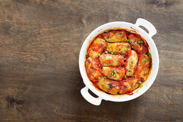 Traditional stuffed cabbage rolls with minced meat and rice, served in a tomato sauce.