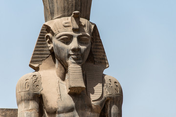 Egypt Luxor Temple. granite Statue of Ramesses II seated in front of columns