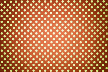 Light orange background from wrapping paper with a pattern of golden polka dot closeup.