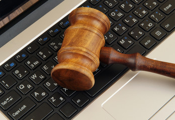 Cyber law or crime concept with judge gavel on laptop computer