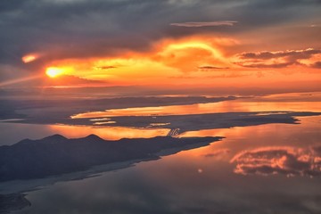 Fototapeta na wymiar Great Salt Lake Sunset Aerial view from airplane in Wasatch Rocky Mountain Range, sweeping cloudscape and landscape during day time in Spring. In Utah, United States.