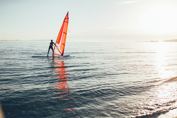Windsurfer balancing on the windsurf board, copy space