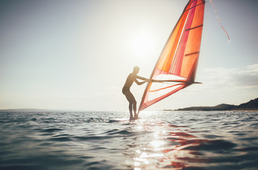 Surfer sailing on the windsurf board, copy space