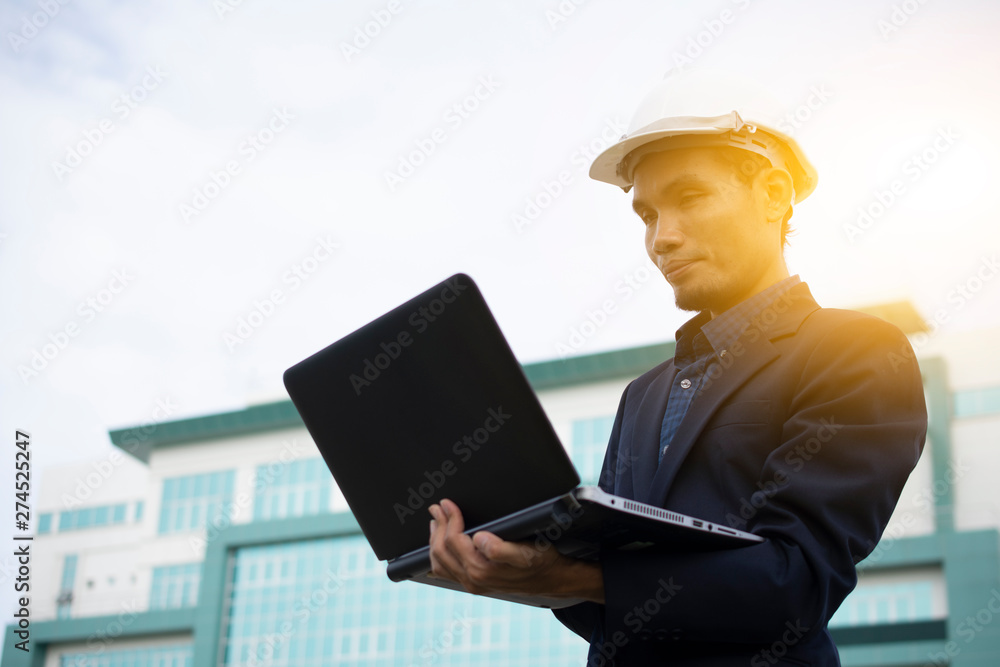 Aufkleber engineer holding computer notebook for work and sky technology background