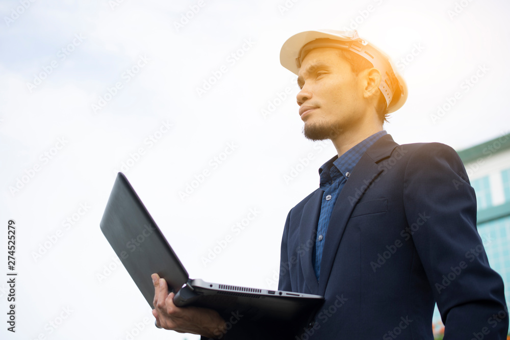 Aufkleber engineer holding computer notebook for work and sky technology background
