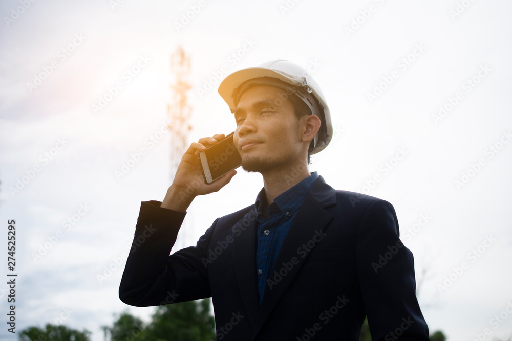 Poster engineer holding mobile smart phone and using to call by internet technology