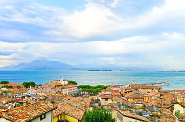 Fototapeta na wymiar View of Desenzano del Garda at the lakeside of Lake Garda in summer. Desenzano del Garda is a popular holiday location in northern Italy.