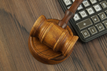 Arbitration concept with wooden gavel and calculator, law concept