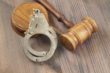 Wooden judge gavel and handcuffs, law and crime concept        