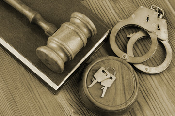 Legal book and  gavel with handcuffs on wooden table, crime and law concept