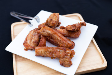 Fried pork on white plate. Thai street food.