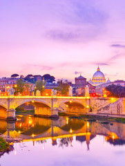 View of St. Peter's Basilica and Bridge King Victor Emmanuel II in Rome at sunset.