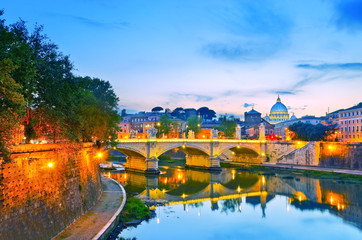 Fototapeta na wymiar View of St. Peter's Basilica and Bridge King Victor Emmanuel II in Rome at sunset.