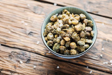 Salt capers on the wooden table