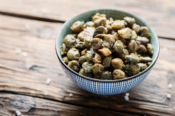 Salt capers on the wooden table