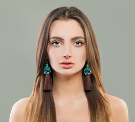Pretty woman in jewelry earrings portrait