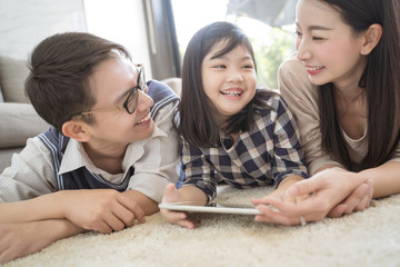happy asian family spending time together in living room. family and home concept