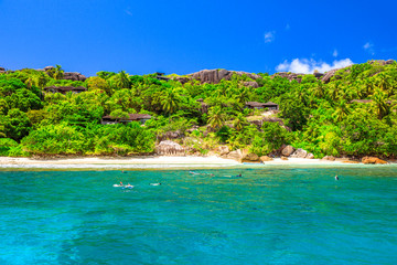 Fototapeta na wymiar Felicite island at Seychelles seascape in Indian Ocean. People snorkel at Ramos National Park. Granite bloulder stones and turquoise bay. Snorkeling paradise in Marine Park. Tropical nature background